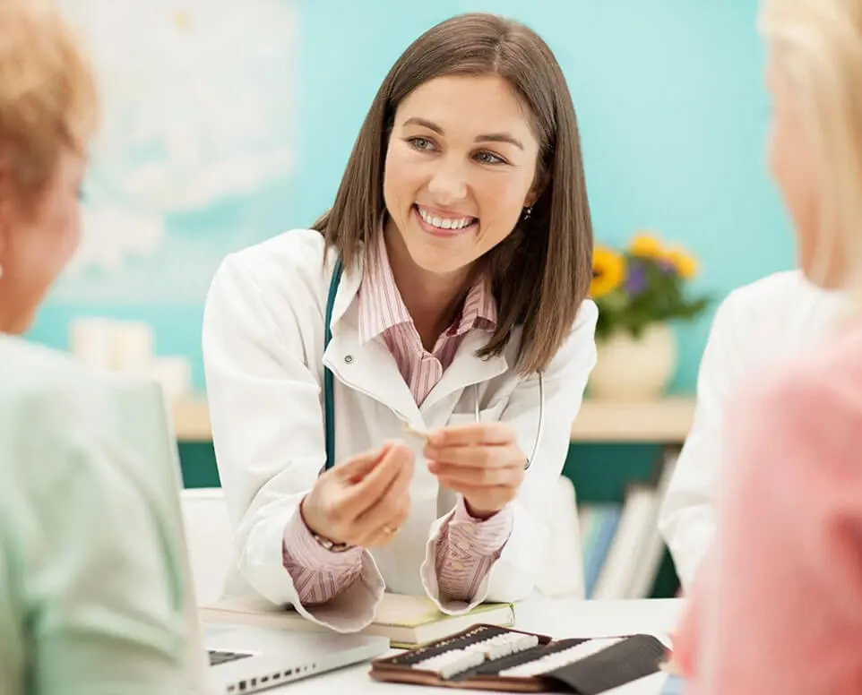 Female Doctor Speaking With Patients